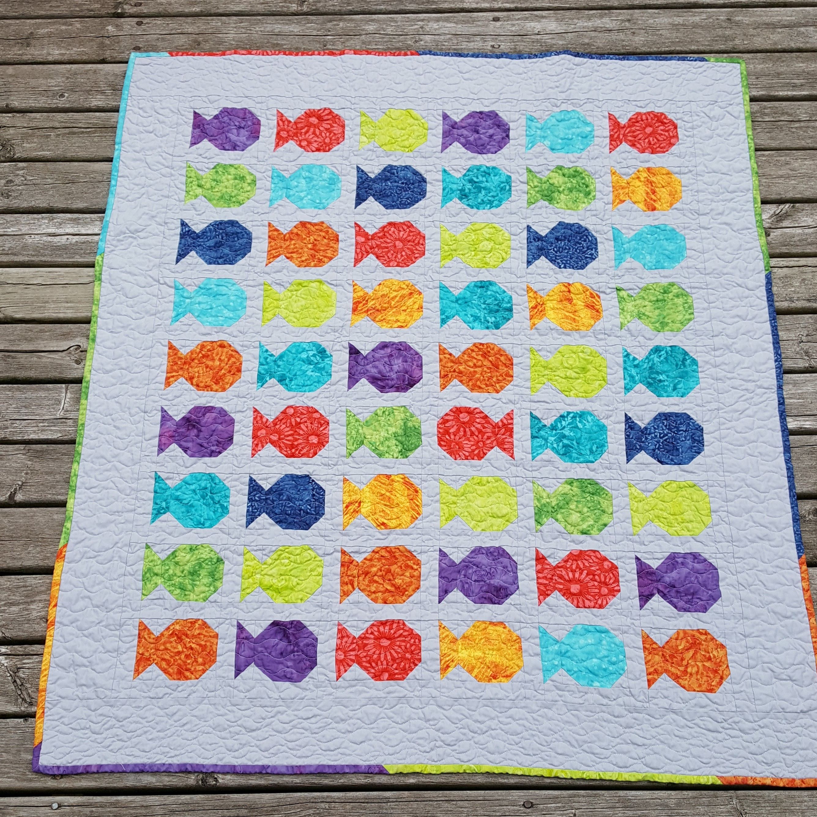 fish quilt with scrappy binding