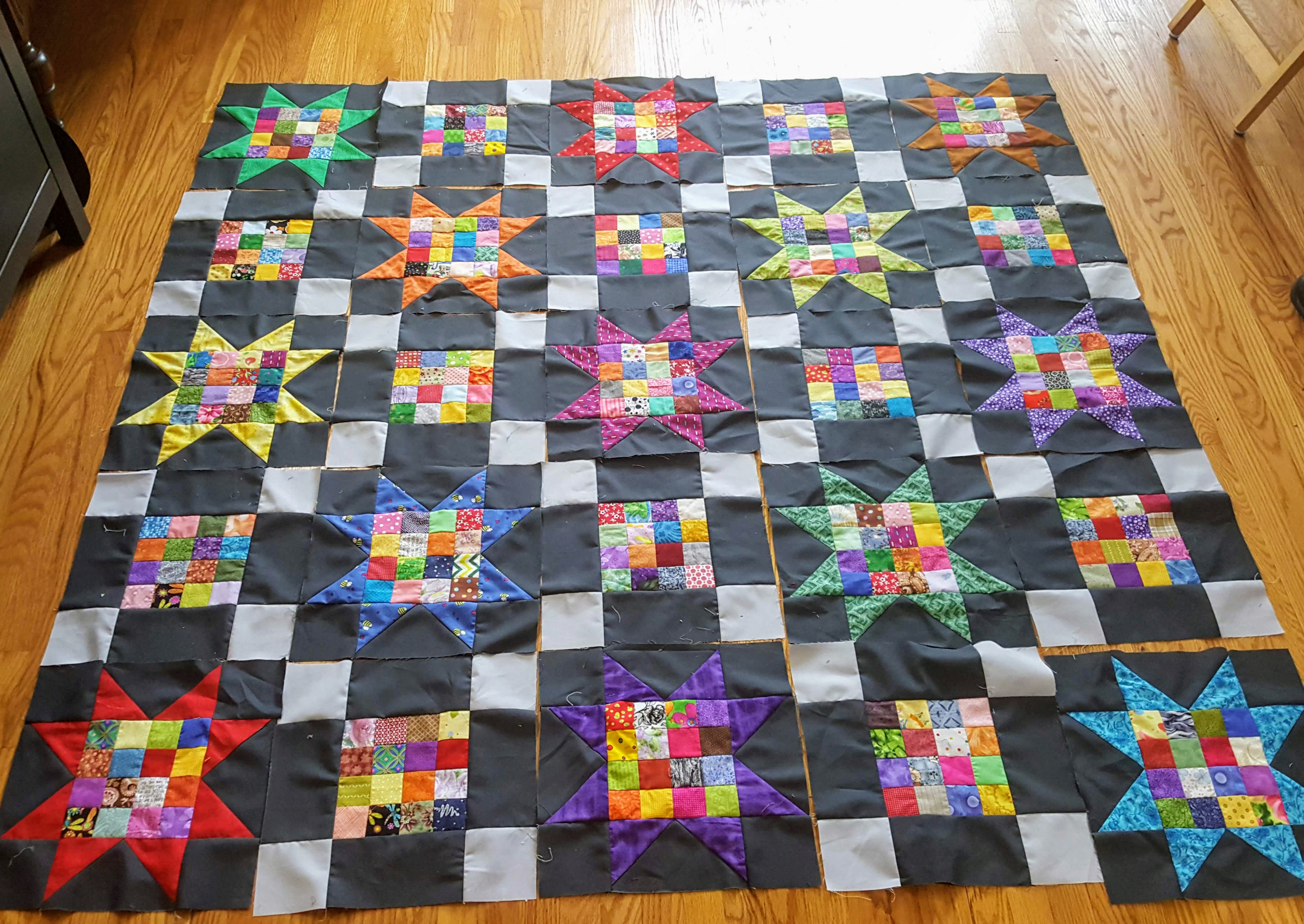 square quilt layout with sawtooth stars and uneven 9 patches