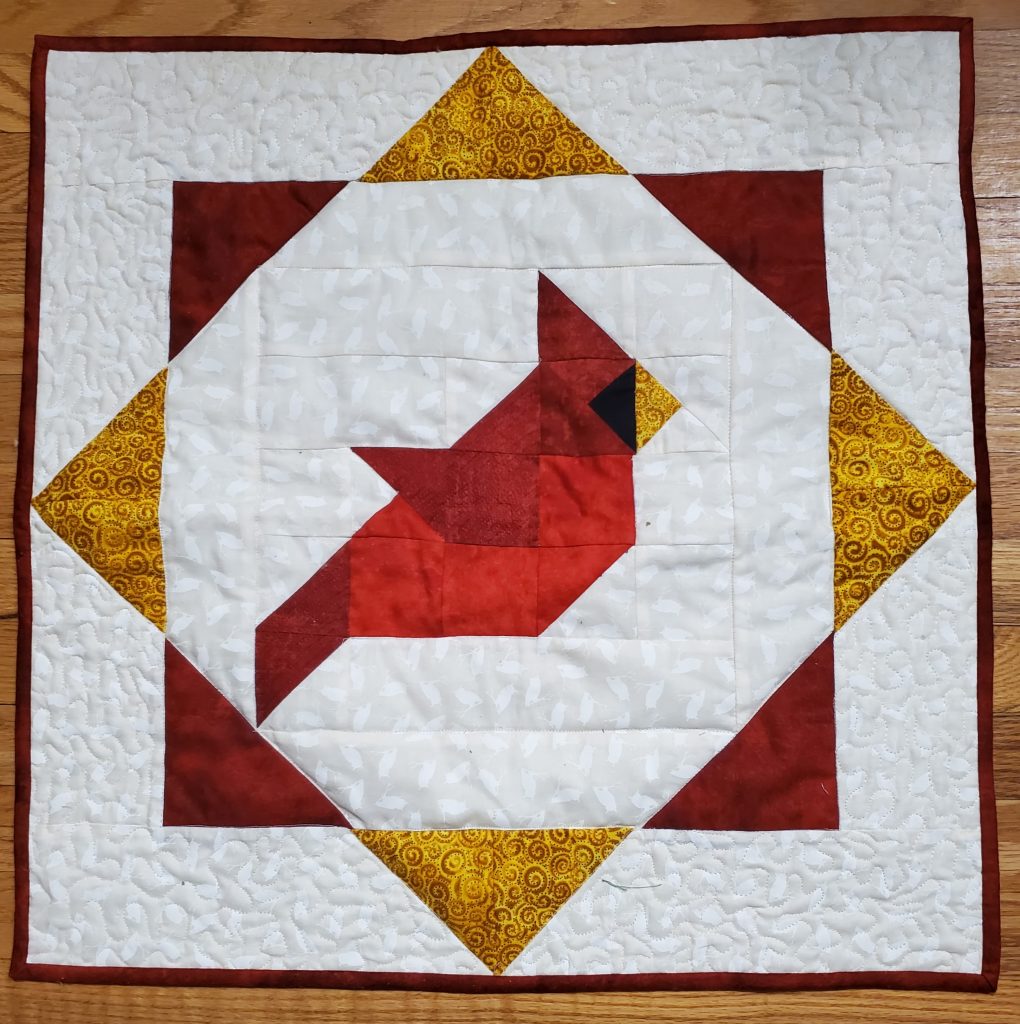 A quilted cardinal quilt block