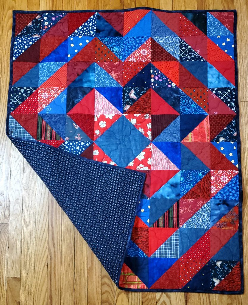 It's Only Triangles by Jordan Fabrics with flannel backing.