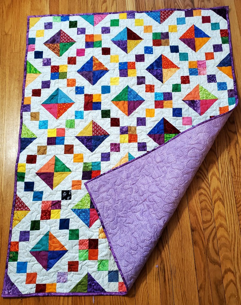 Jewel Box baby quilt showing the backing
